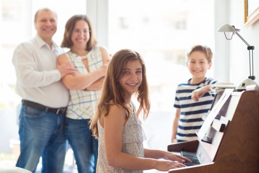 Happy young family piano