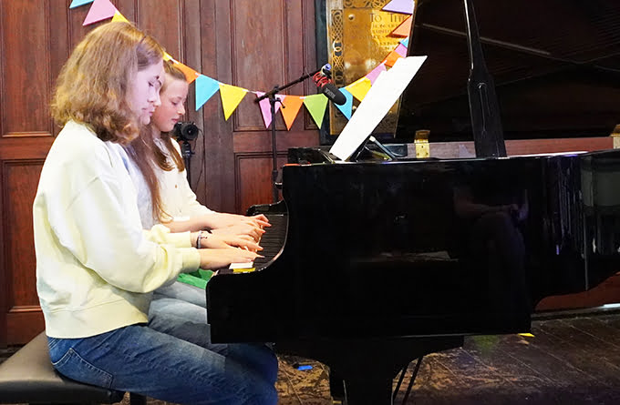 Three students from Colourful Keys Piano Studio performing in a concert
